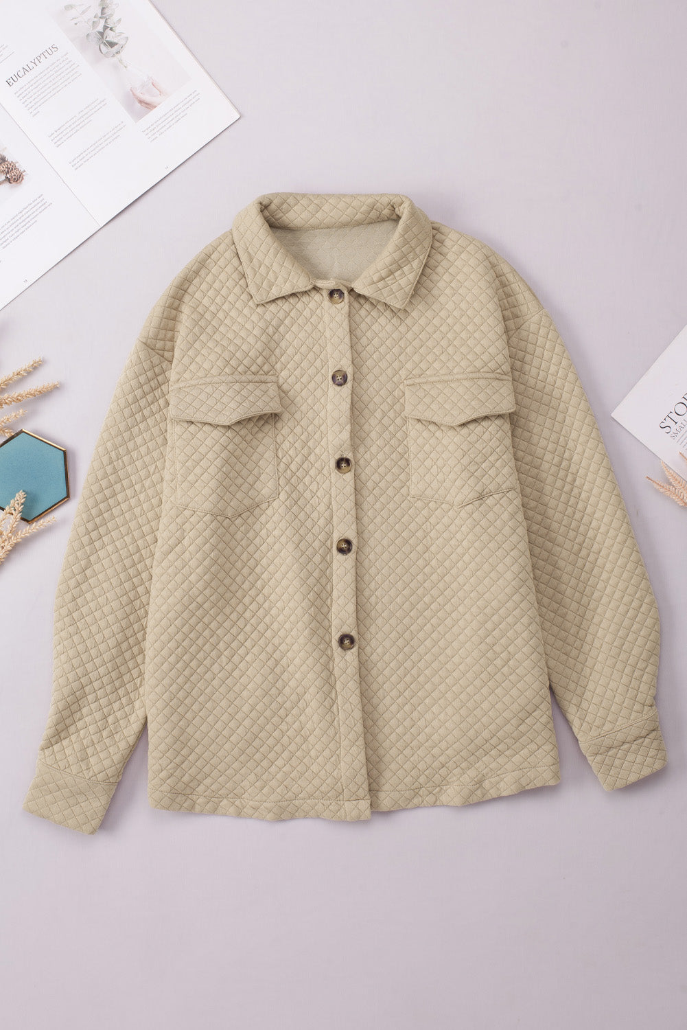 Quilted overshirt in tan with button front and patch pockets.