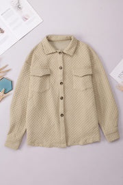 Quilted overshirt in tan with button front and patch pockets.
