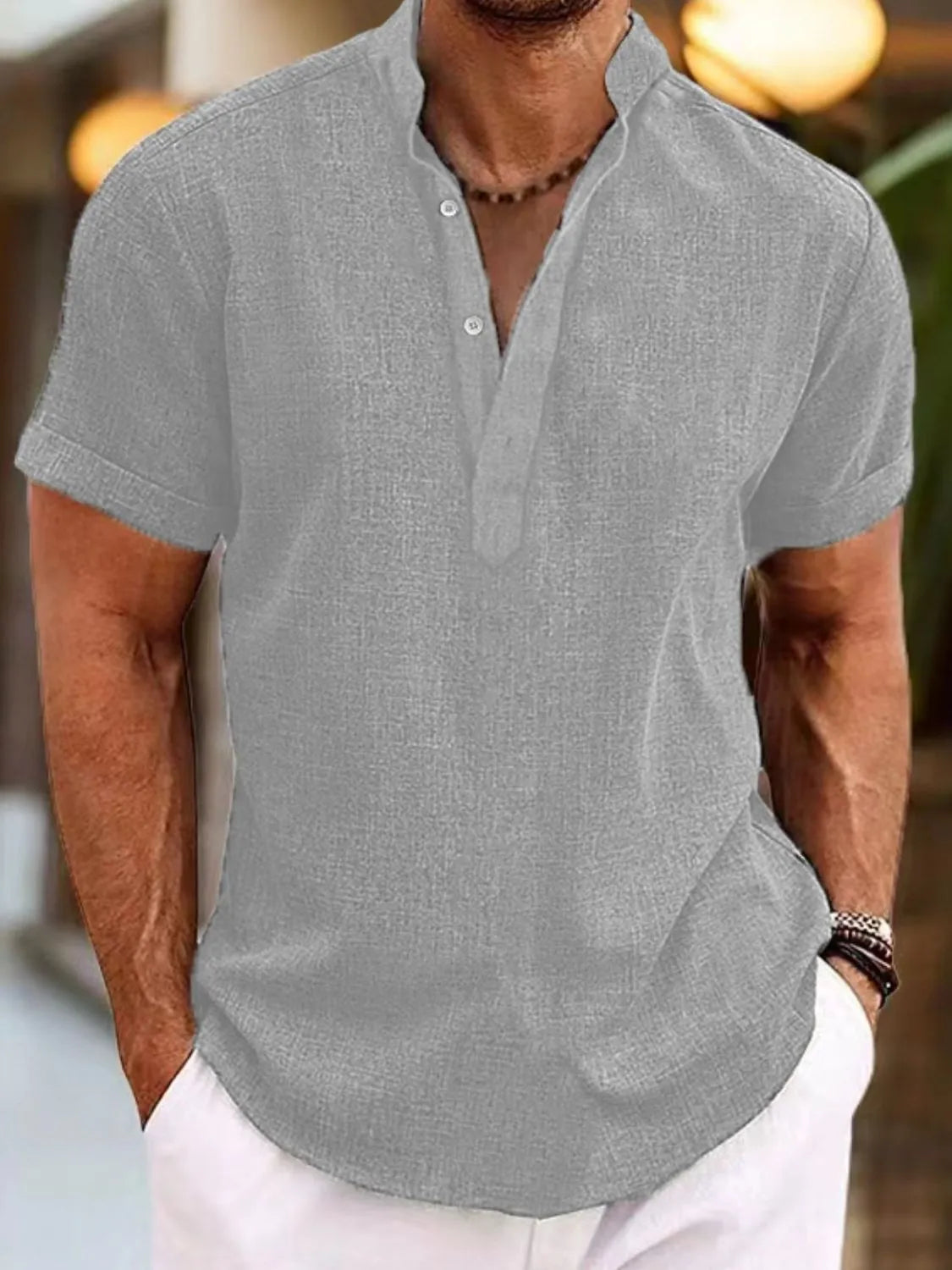 Gray linen blend henley shirt with mandarin collar and short sleeves.