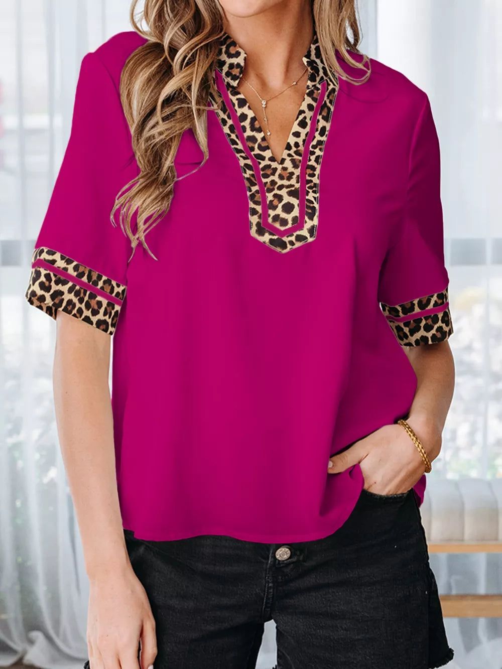 Fuchsia split neck blouse with leopard trim on neckline and sleeves.