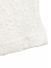 White eyelet lace crop t-shirt with textured floral pattern and bow detail.