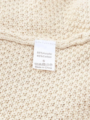 Beige knit sweater with care tag showing 55% Acrylic, 45% Cotton.