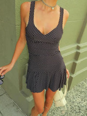 Black polka dot crop top and flared skirt set with a V-neck and ruffled hem.