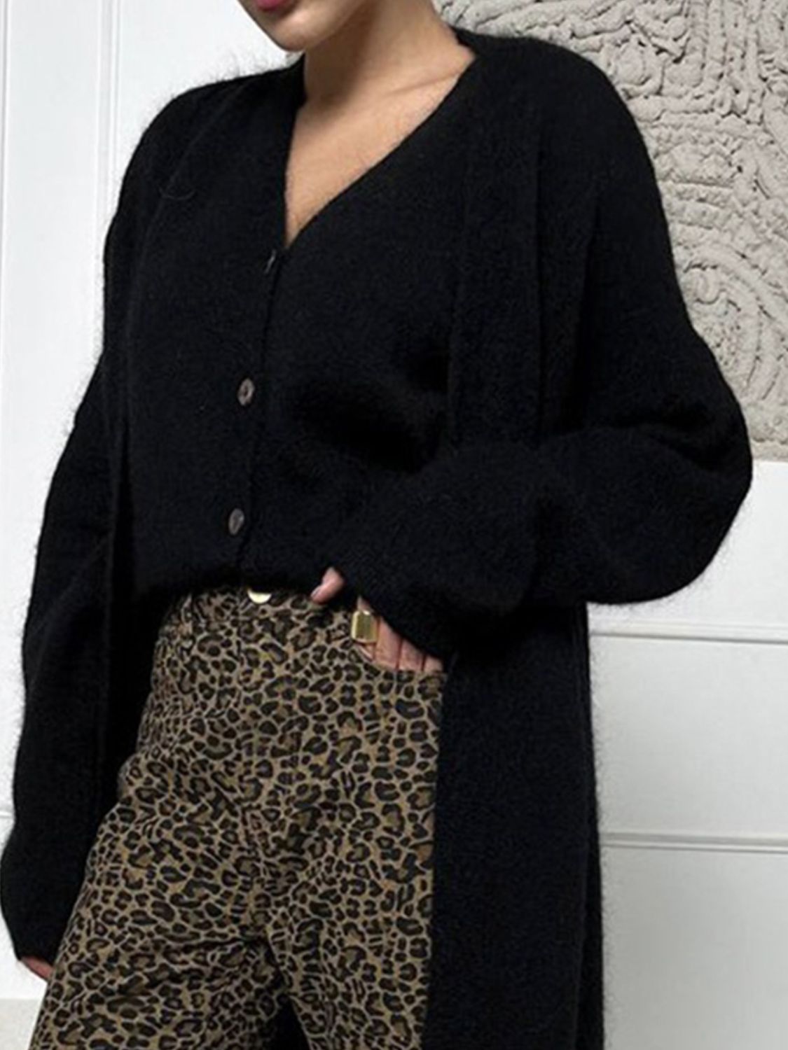 Black plush maxi cardigan with balloon sleeves and button front, styled with leopard print pants.