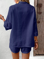 Navy cotton two-piece set with buttoned shirt and shorts.