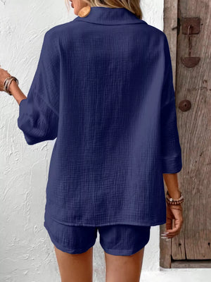Navy cotton two-piece set with buttoned shirt and shorts.