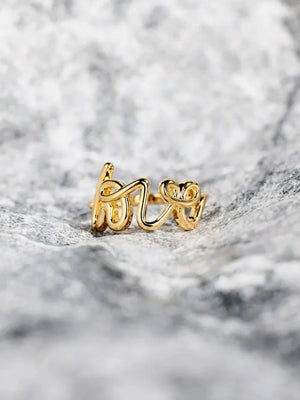 Gold scripted love ring with delicate cursive lettering