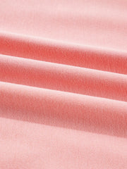 Oversized dusty pink sweatshirt with contrast stitching detail, showing textured fabric.