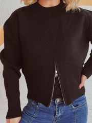 Black ribbed zip-front knit sweater with mock neck and long sleeves.