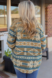 Aztec print shacket in dusty blue with button front and patch pockets.