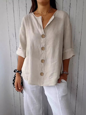 Beige button-down shirt with relaxed fit and three large buttons, 3/4 sleeves.