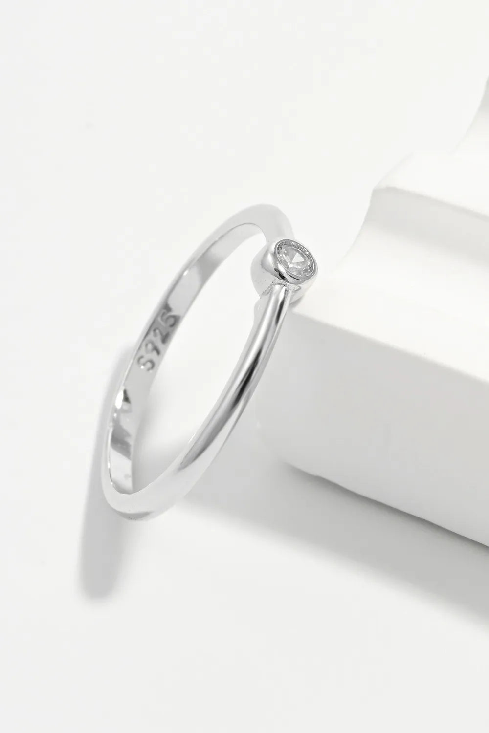Solitaire silver ring with zirconia, 925 sterling silver band, minimalist design.