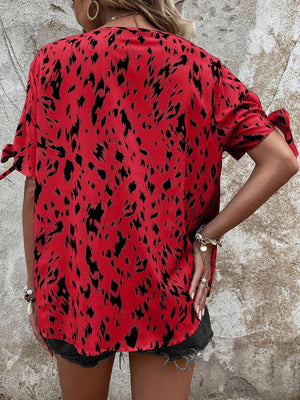 Scarlet Dalmatian print blouse with tie bow sleeves and a boatneck.