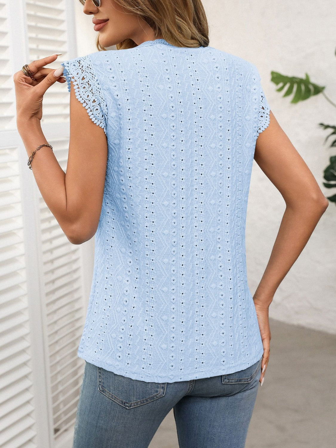 Light blue eyelet cap sleeve blouse with lace trim on sleeves.