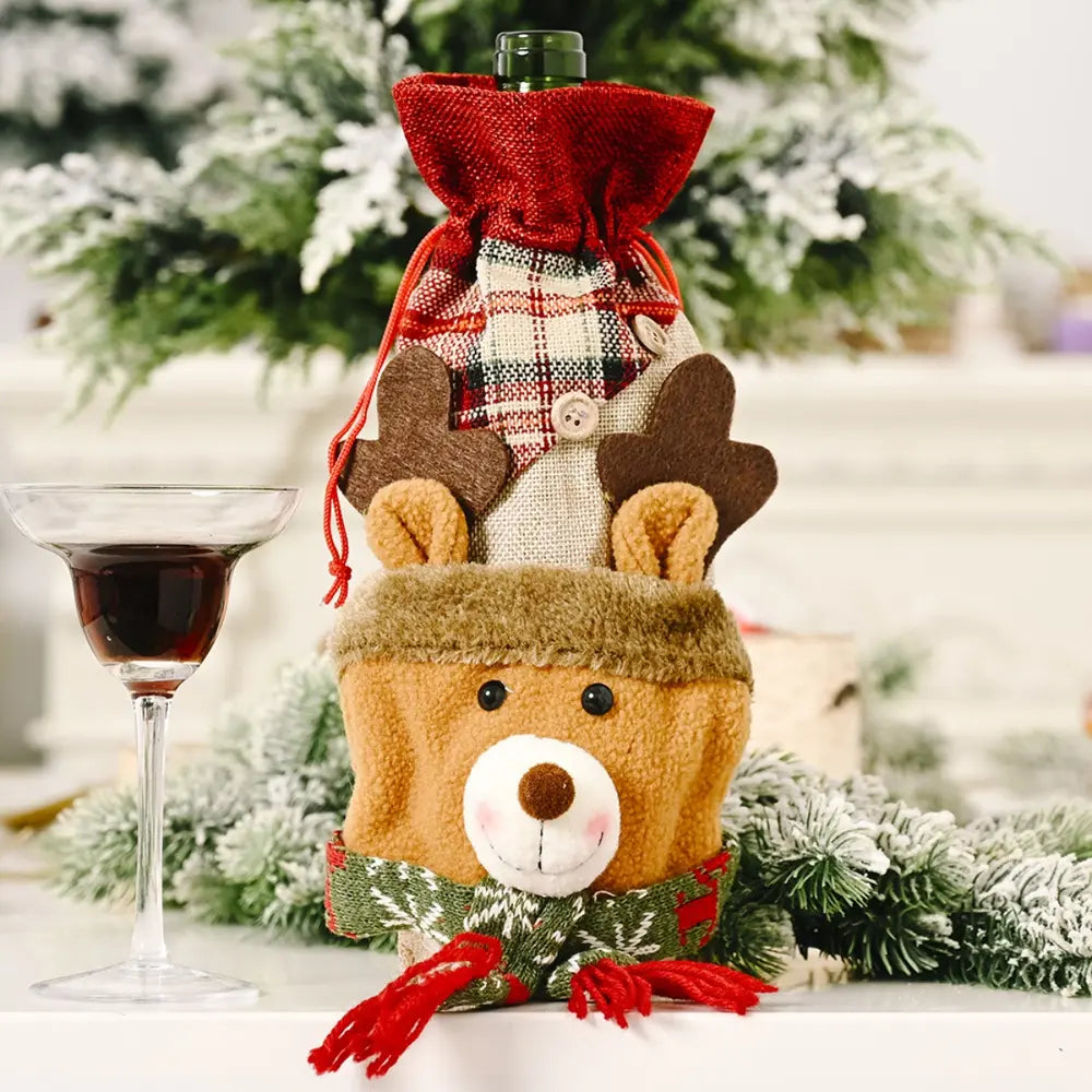 Holiday wine bottle cover with reindeer face, plaid fabric top, and red scarf detail.