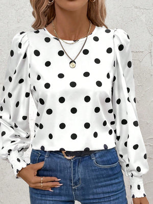 White polka dot blouse with smocked cuffs and puffed sleeves.