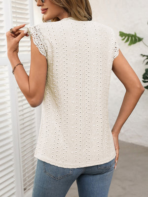 Eyelet detail cap sleeve top in eggshell with intricate lace trim on sleeves.