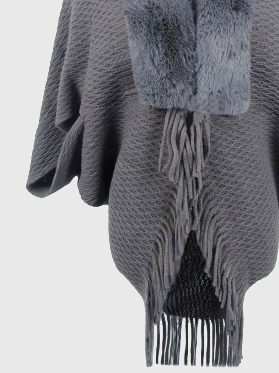 Textured knit poncho in charcoal with faux fur collar and fringe detail.