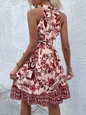 Floral print tie-waist mini dress with halter neck and ruffled hem.