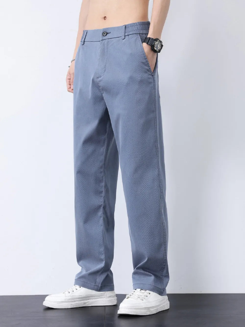 Relaxed fit light blue casual pants with subtle texture and elastic waistband.