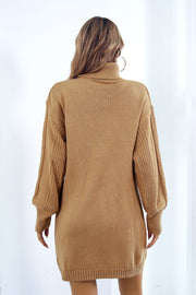 Camel cable knit turtleneck sweater dress with blouson sleeves and textured sleeve detail.