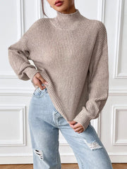 Relaxed fit beige ribbed knit turtleneck sweater with long sleeves.