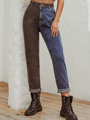 Split-tone straight leg jeans in medium wash denim and charcoal with cuffed hems.