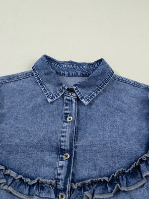 Vintage wash denim button-down shirt with ruffled hem and button front detail.