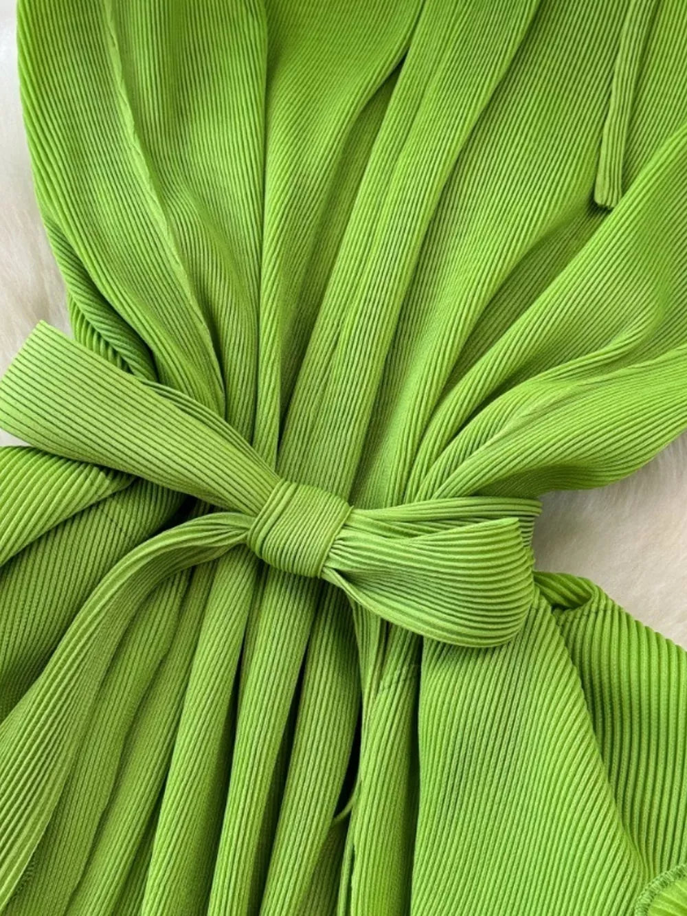 Lime green pleated midi dress with a belted waist and ruffled tiers.