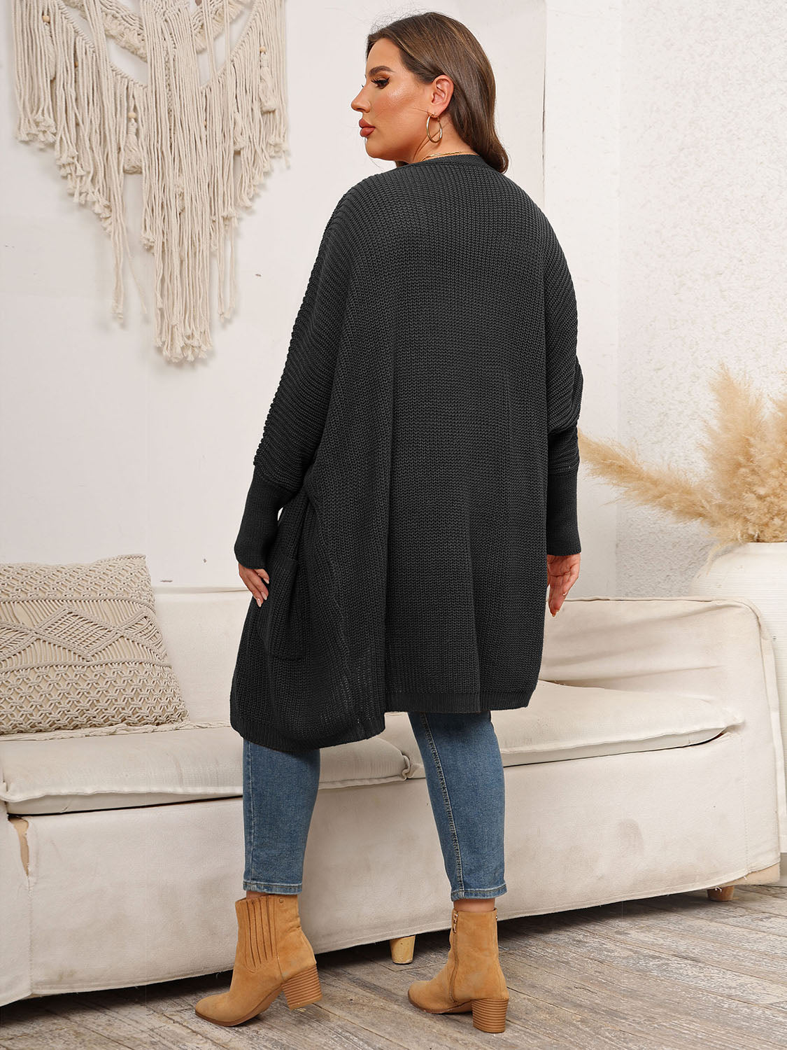Black oversized ribbed knit duster cardigan with pockets and long sleeves