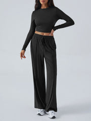 Black ribbed knit long sleeve crop top and drawstring wide leg pants set.