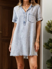 Light acid wash shirtdress with contrast stitching, short sleeves, collar, and frayed hem.