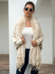 Ivory faux fur trimmed fringe cape with a boho casual style.