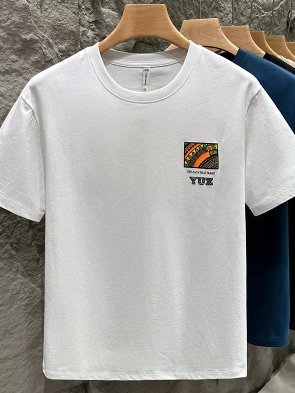 White cotton crew t-shirt with abstract graphic detail and text.