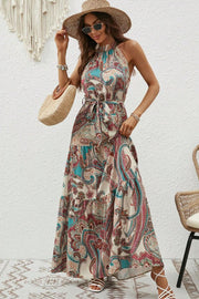 Halter neck paisley maxi dress with tie waist and tiered skirt in tan, teal, and pink.