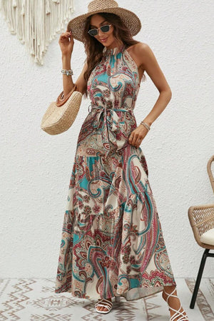 Halter neck paisley maxi dress with tie waist and tiered skirt in tan, teal, and pink.