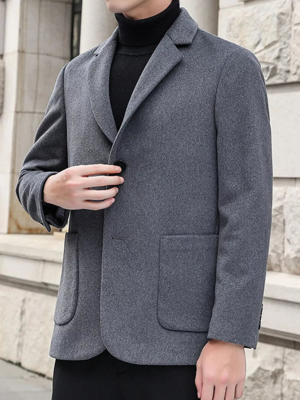 Men's grey lapel collar blazer with button closure and flap pockets.