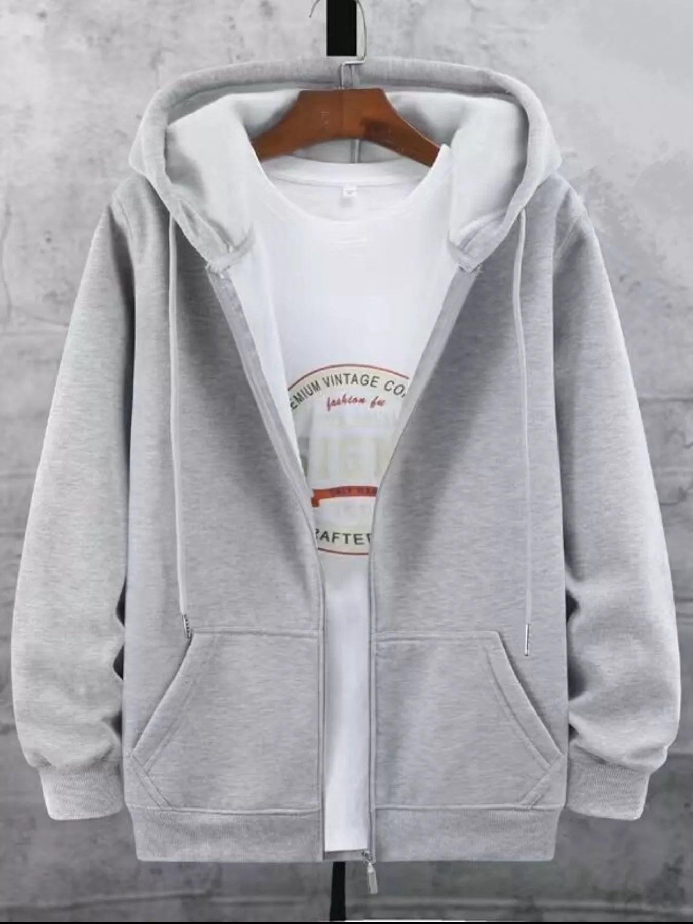 Gray fleece-lined zip-up hoodie with a white graphic t-shirt underneath.