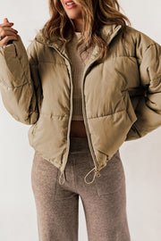 Taupe cropped puffer jacket with hood, full zip, and drawstring hem.