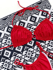 Red ruffle tie bikini set with adjustable straps and a geometric print background.