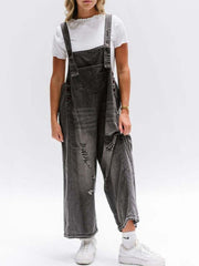 Ripped relaxed fit denim overalls in dark blue with distressed details and adjustable straps.