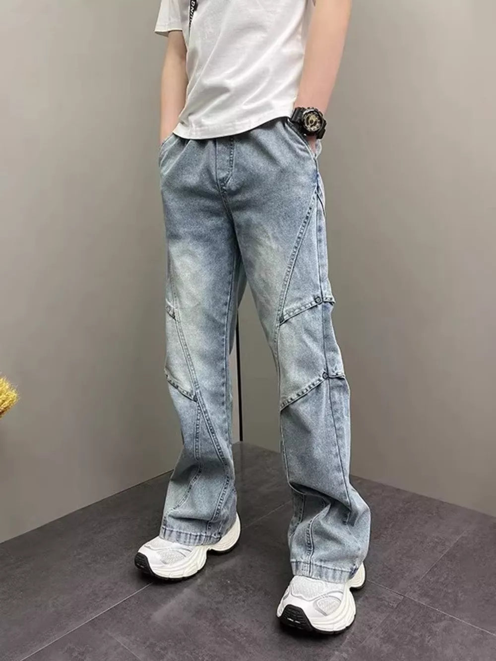 Distressed light blue vintage wide-leg jeans for him with paneling detail.