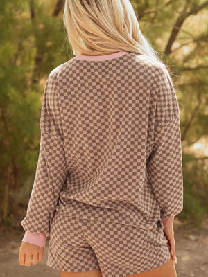 Chic checkerboard loungewear set with pink trim.