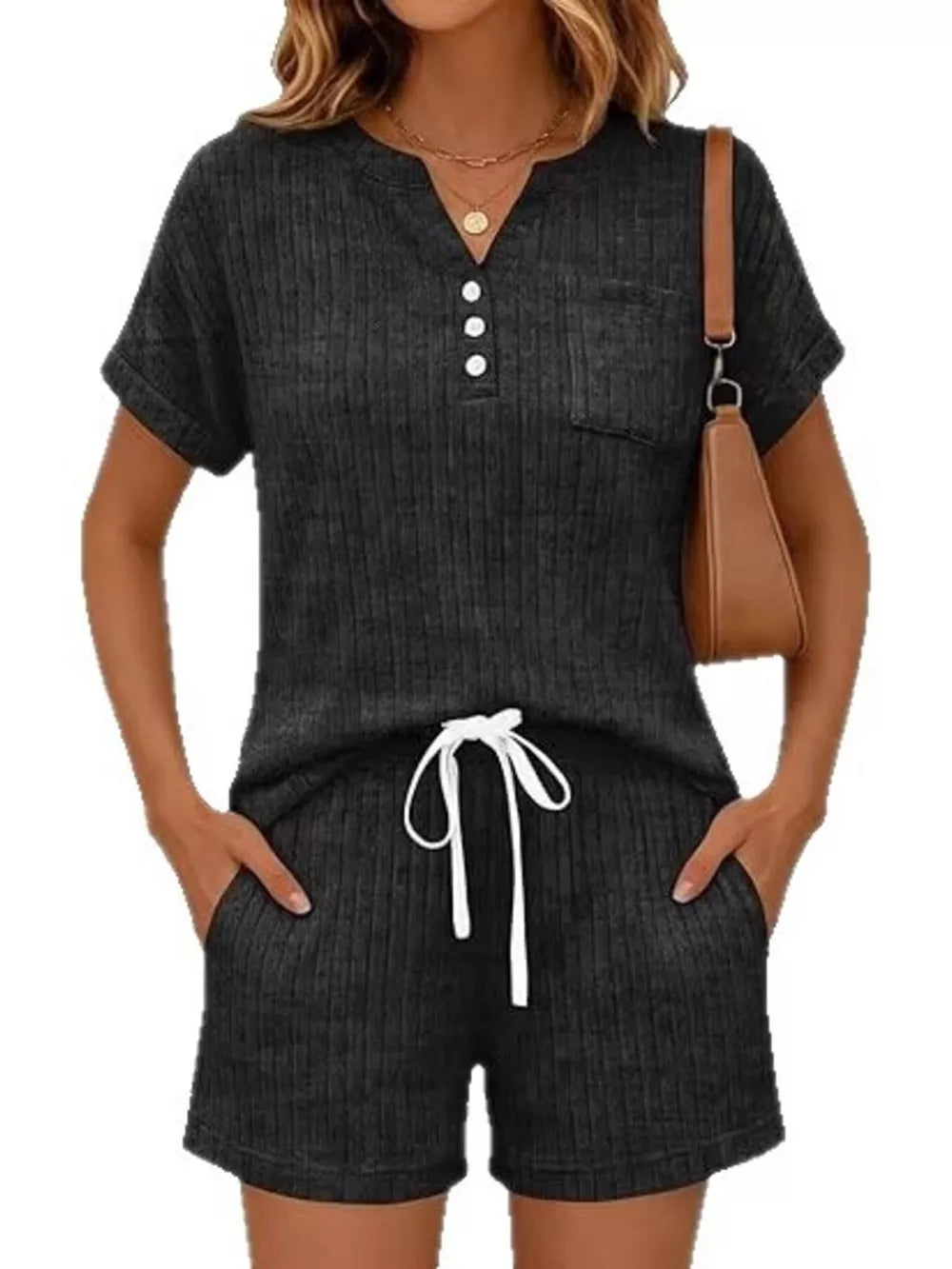 Black ribbed knit loungewear set with henley neckline, pocket, and drawstring shorts.
