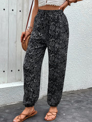 Black printed jogger trousers with gathered ankles and a drawstring waist.