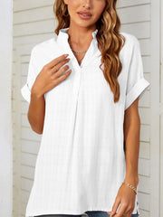 White linen blend blouse with gathered yoke, V-neck, and cuffed short sleeves.