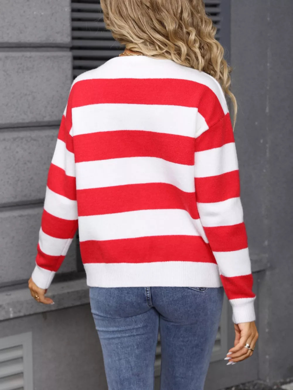 Red and white striped acrylic cardigan with crew neck, long sleeves, and ribbed cuffs.