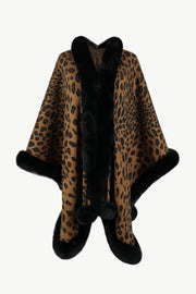 Leopard print cape with black faux fur trim and pom-poms.