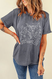 Gray graphic t-shirt with western tattoo print, featuring a bull skull, boots, and hearts.