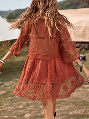 Bohemian rust lace tiered mini dress with bell sleeves and intricate floral embroidery.